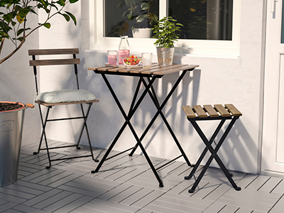 An outdoor table and two chairs