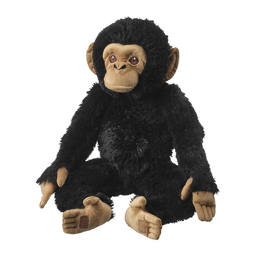 Mono de peluche negro, sentado, cara suave y realista, manos y pies marrones.