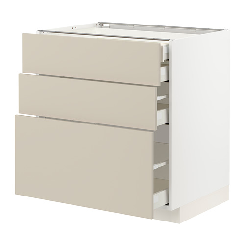 Un mueble METOD blanco de ikea con tres cajones beige. El armario tiene un diseño liso y limpio con cajones de cierre automático.
