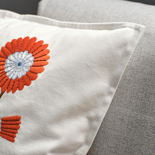 Funda de cojín bordada floral, flor naranja brillante sobre tela blanca, almohada lumbar de terciopelo, aspecto acogedor y artesanal.
