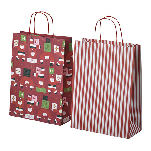 Dos bolsas festivas, una roja con motivos navideños, la otra con rayas rojas y blancas, hechas de papel, que se muestran de pie.