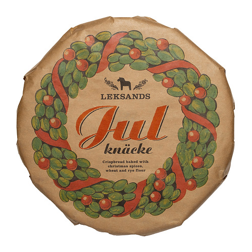 Caja redonda de cartón de pan crujiente leksands julknäcke, con un diseño de corona navideña.