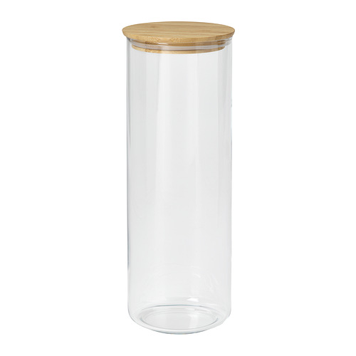 Un frasco de vidrio transparente llamado EKLATANT con tapa de madera. Es cilíndrico, apto para almacenar alimentos, y tiene un diseño sencillo y elegante.