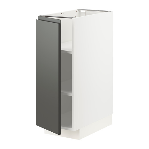 Un mueble de cocina METOD blanco con puerta gris oscuro y estantes ajustables. Diseño moderno, aspecto bicolor.