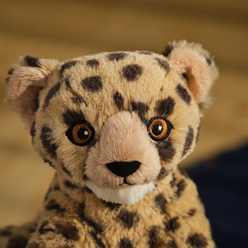 Peluche de guepardo, detallado con tela suave y reciclada, ojos realistas y una sonrisa acogedora.