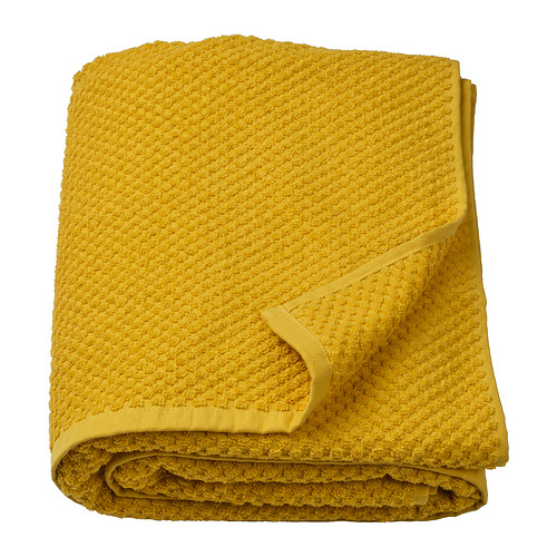 Una toalla GULVIAL amarilla doblada hecha de 100% algodón, rectangular con una superficie texturizada.