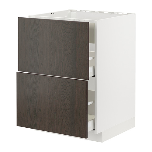 Frentes de cajones marrón oscuro con cantos de madera maciza sobre armario blanco.