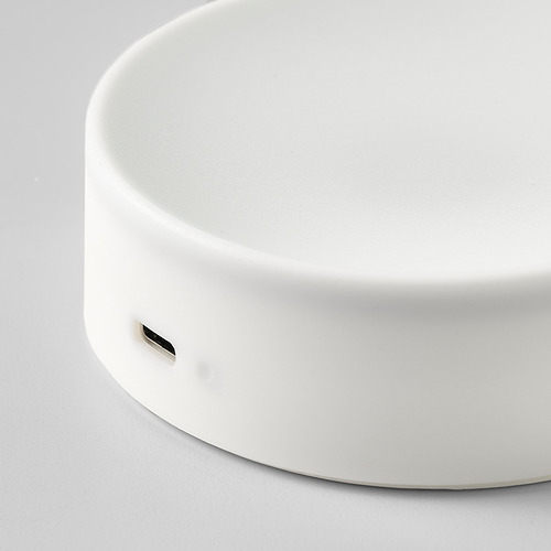 Lámpara redonda, blanca, moderna, con superficie lisa y puerto de carga usb-c.