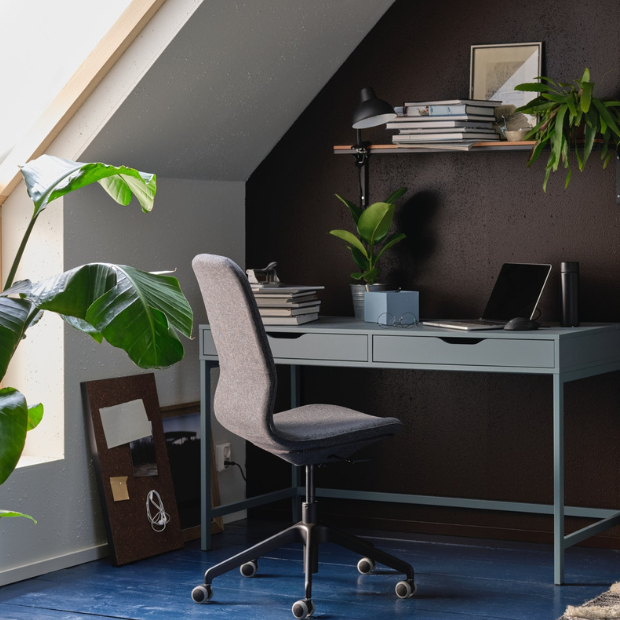 Home office with desk, comfortable chair and storage space