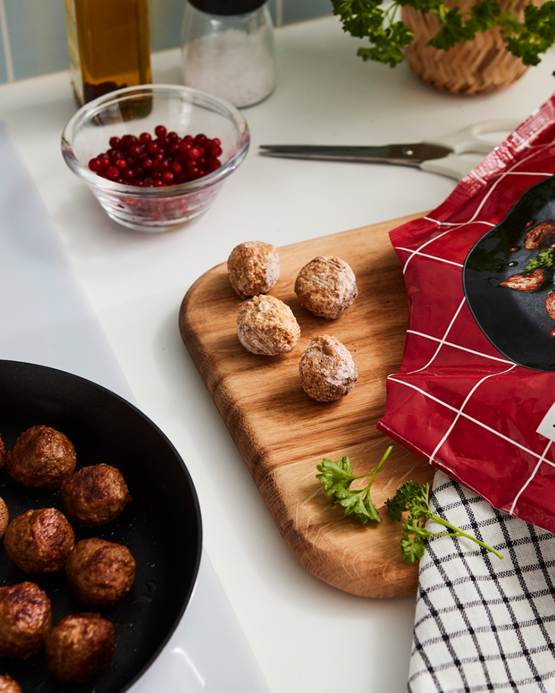 Albóndigas suecas de IKEA sobre un sartén y una tabla de madera.