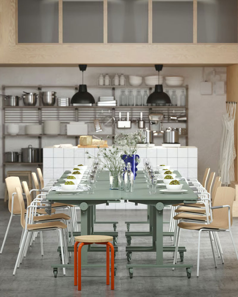 Several green MITTZON tables arranged for dining, paired with LÄKTARE conference chairs and an orange/pine DOMSTEN stool
