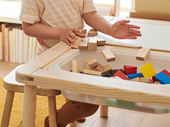 a child putting toys on his children's table