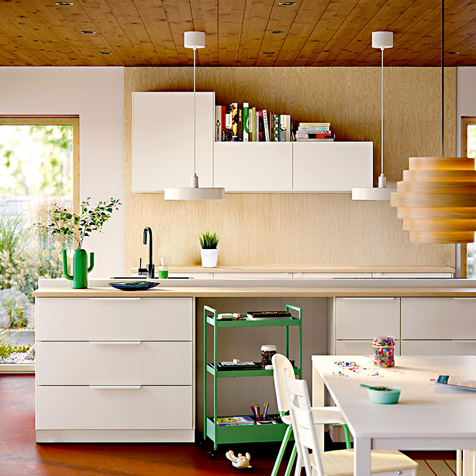 Kitchen with white cabinets, a wooden countertop, and a green metal cart.