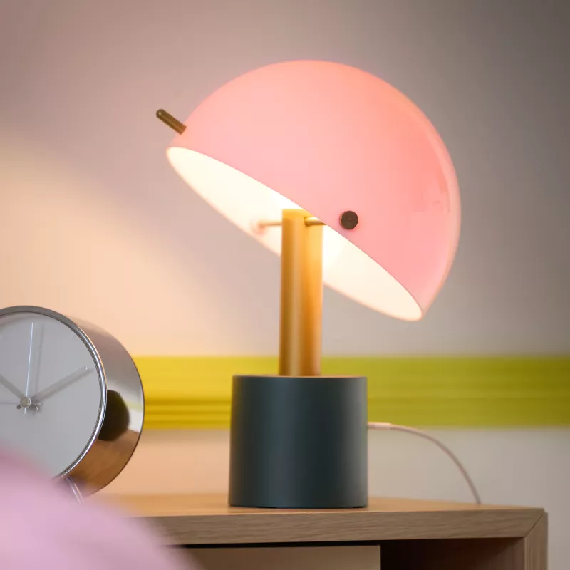 LED NÖDMAST lamp on nightstand beside alarm clock, cozy and minimal setup.