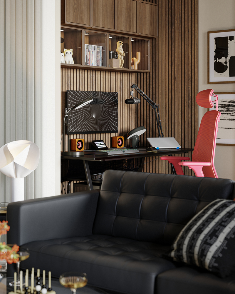 Un sofá de tres plazas se encuentra frente a una zona de juegos con un escritorio UTESPELARE y una silla STYRSPEL roja.