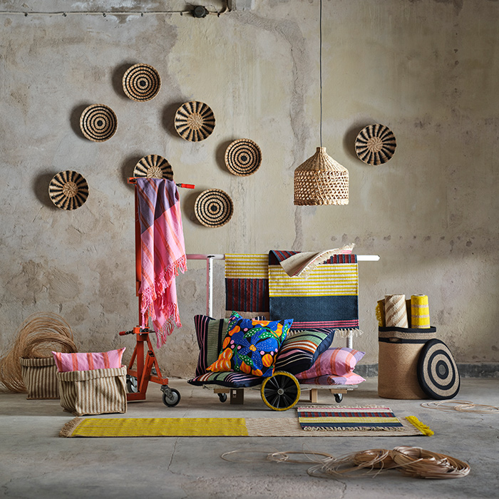The MÄVINN collection is surrounded by concrete walls and floor. Natural fibres mix with textiles in pink, blue and yellow.