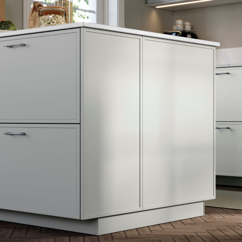 ASPUDDEN light-grey fronts and cover panels on a kitchen island, in a kitchen with fishbone patterned wooden floors.