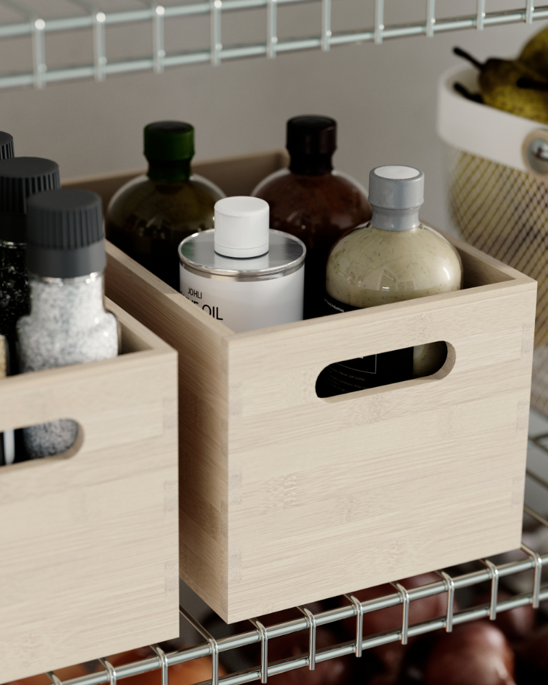 An UPPDATERA storage box in light wood, placed on an OMAR shelf and filled with bottles beside jars and other pantry items.