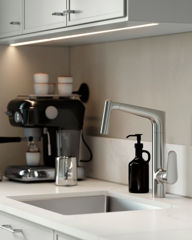 MAJSJÖN kitchen mixer tap pull out with spray, placed above a sink with white worktop and black soap dispenser.