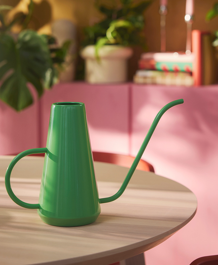 Set of illuminated paper stars with a lace design, hung above a dining table decorated for the festive season.