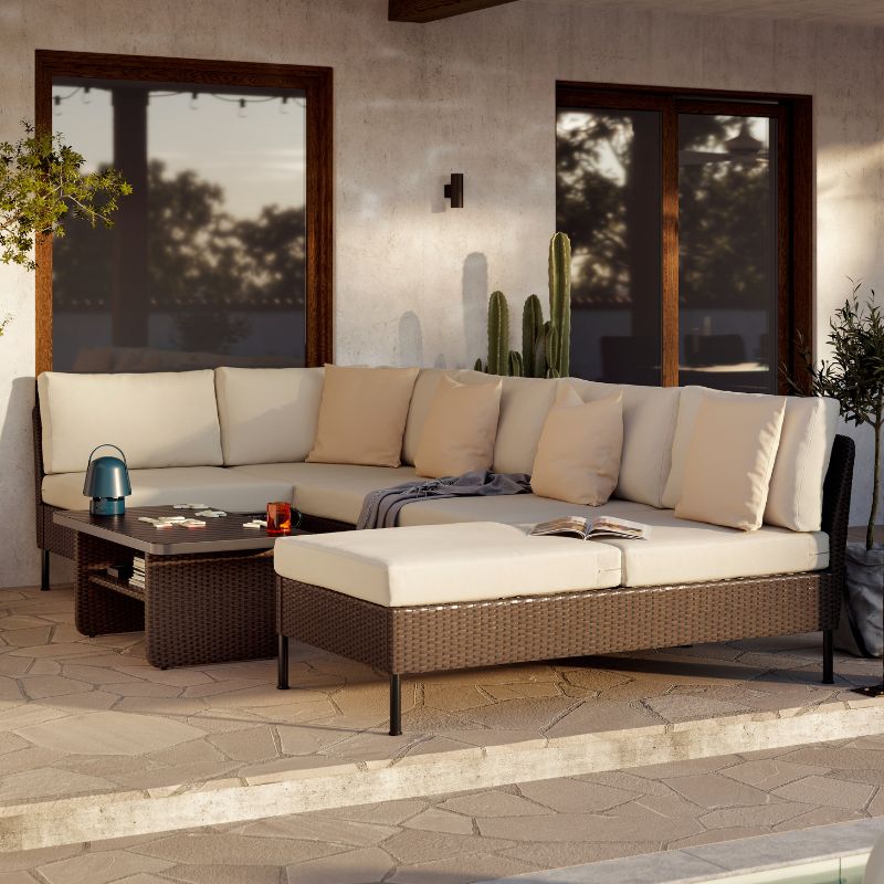A generous outdoor lounge area with VITTSKÄR modular sofas and coffee table in dark grey. A large plant pot next to it.