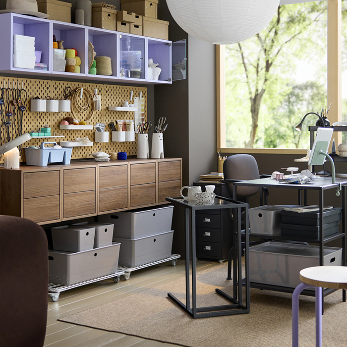 A workspace area by a window with multiple EKET wall cabinets in walnut effect featuring two drawers, next to a VITTSJÖ desk.