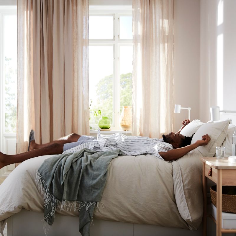 Translucent curtain, pair on the bed