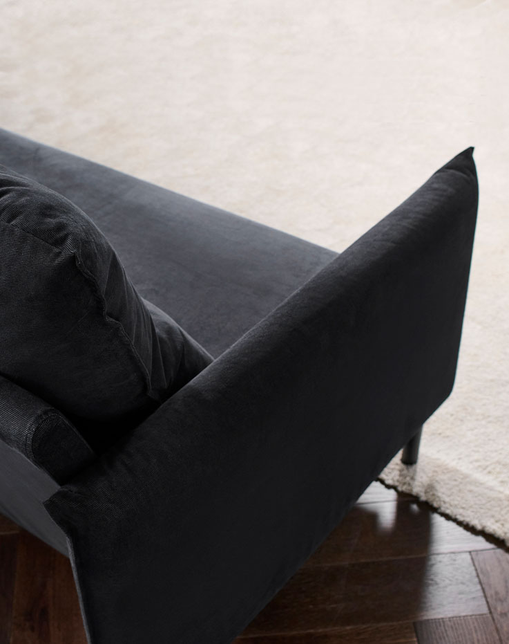 Backrest and black furniture legs on a rug