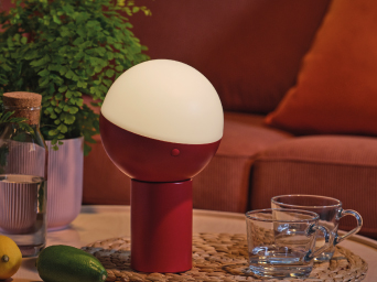 LED lighting, accompanied by glasses, a glass bottle, and a potted plant on a table