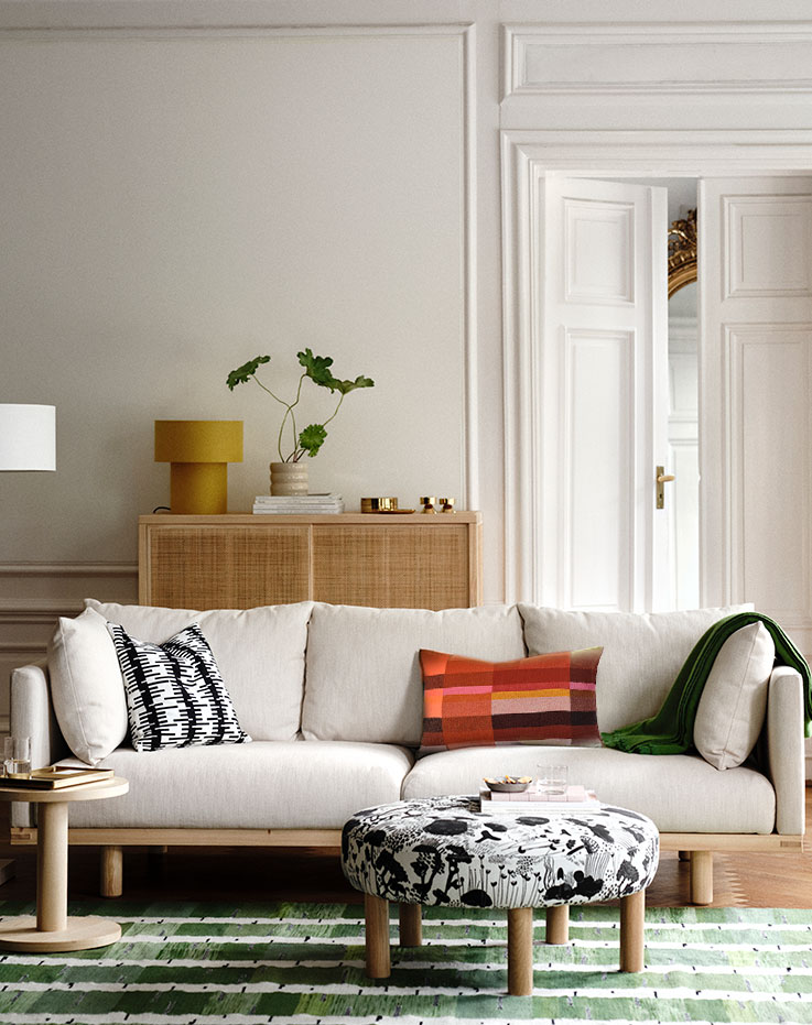 Living room  with a sofa, cushions, and a coffee table.