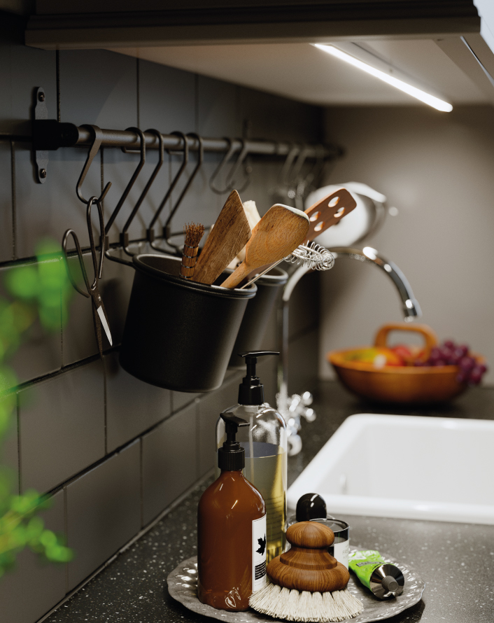 Kitchen counter with hanging utensils, soap dispensers, and sink, all arranged in a functional and tidy way.