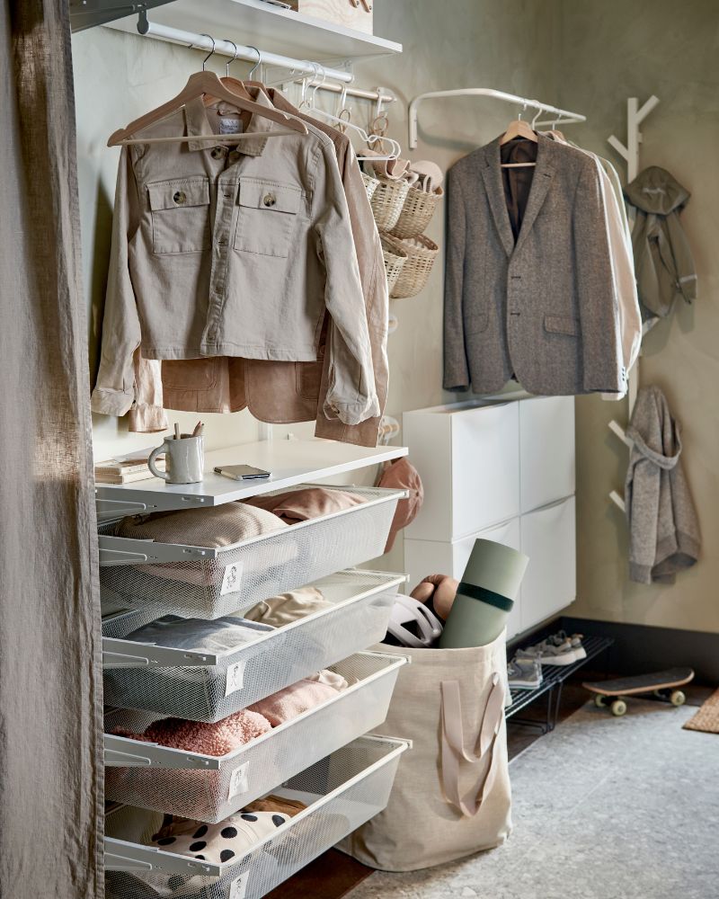 Organized entryway with BOAXEL wall system, TRONES shoe storage, PURRPINGLA laundry bags and NEREBY rails with hooks.