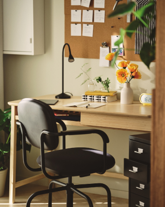 Workspace with a wooden desk and black chair.