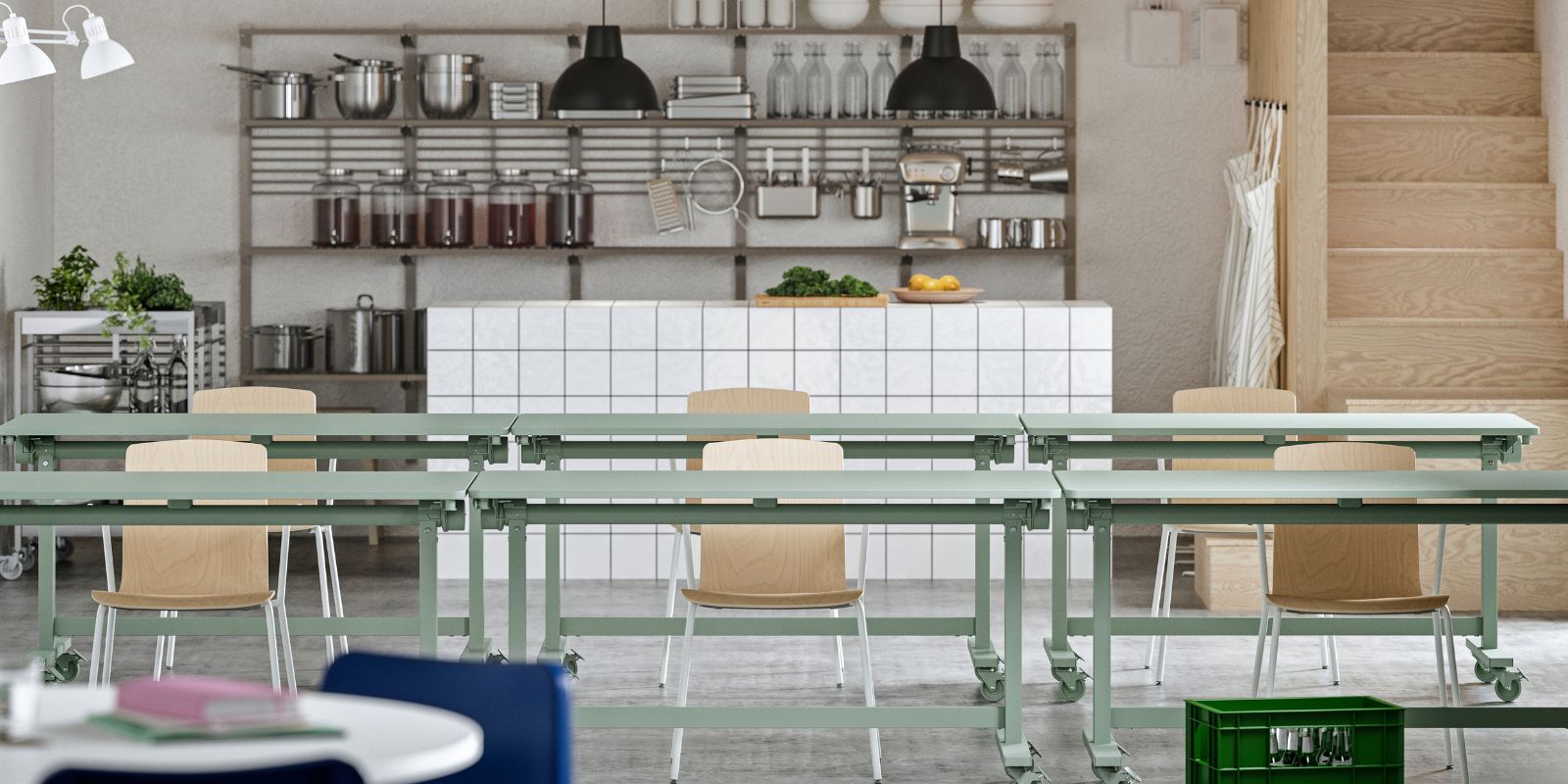 A workspace with event furniture, including green MITTZON foldable tables, LÄKTARE conference chairs, and open shelving.
