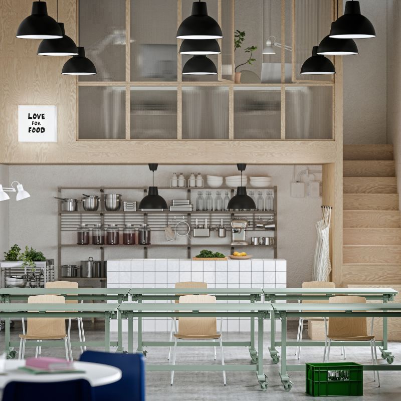 A workspace with event furniture, including green MITTZON foldable tables, LÄKTARE conference chairs, and open shelving.