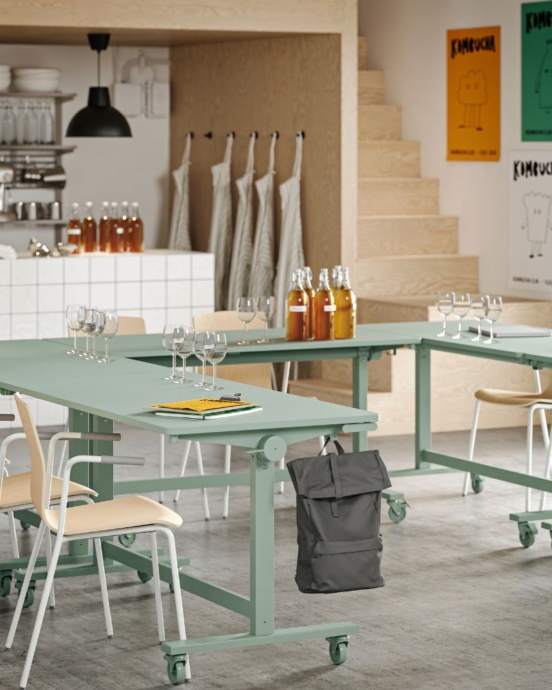 Several green MITTZON foldable tables arranged in a U-shape, paired with LÄKTARE conference chairs