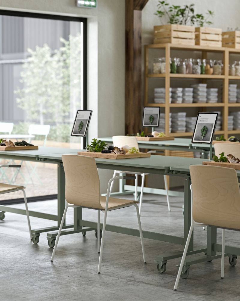 MITTZON foldable tables and LÄKTARE chairs in a classroom setting, with RELATERA tablet holders and bamboo butcher’s blocks